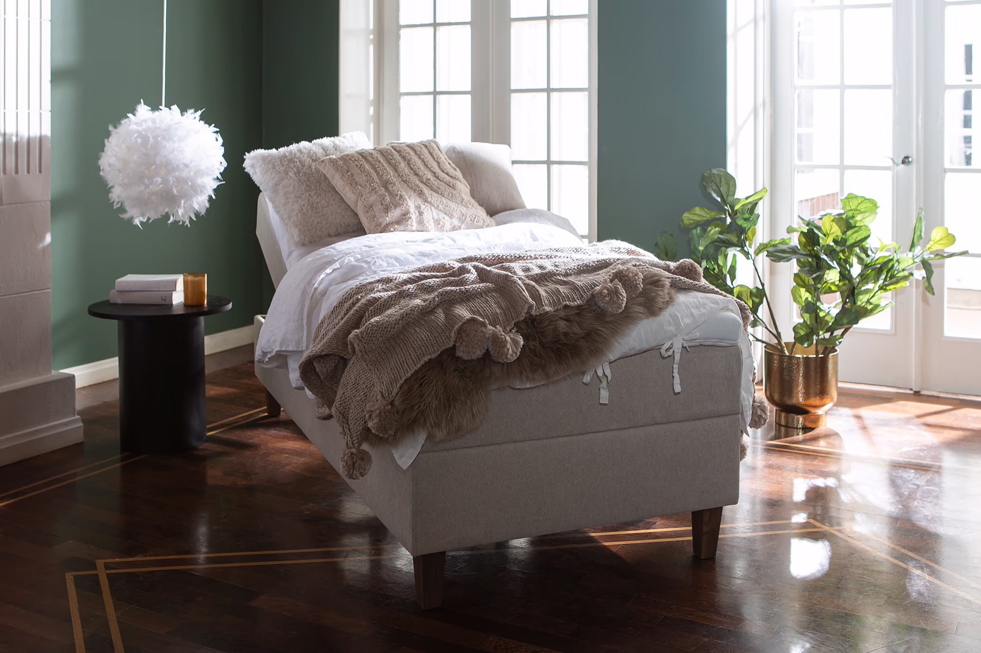 Moon Bronze motorized bed in light gray color, showing the elegant adjustable frame and tall cone-shaped smoked ash legs