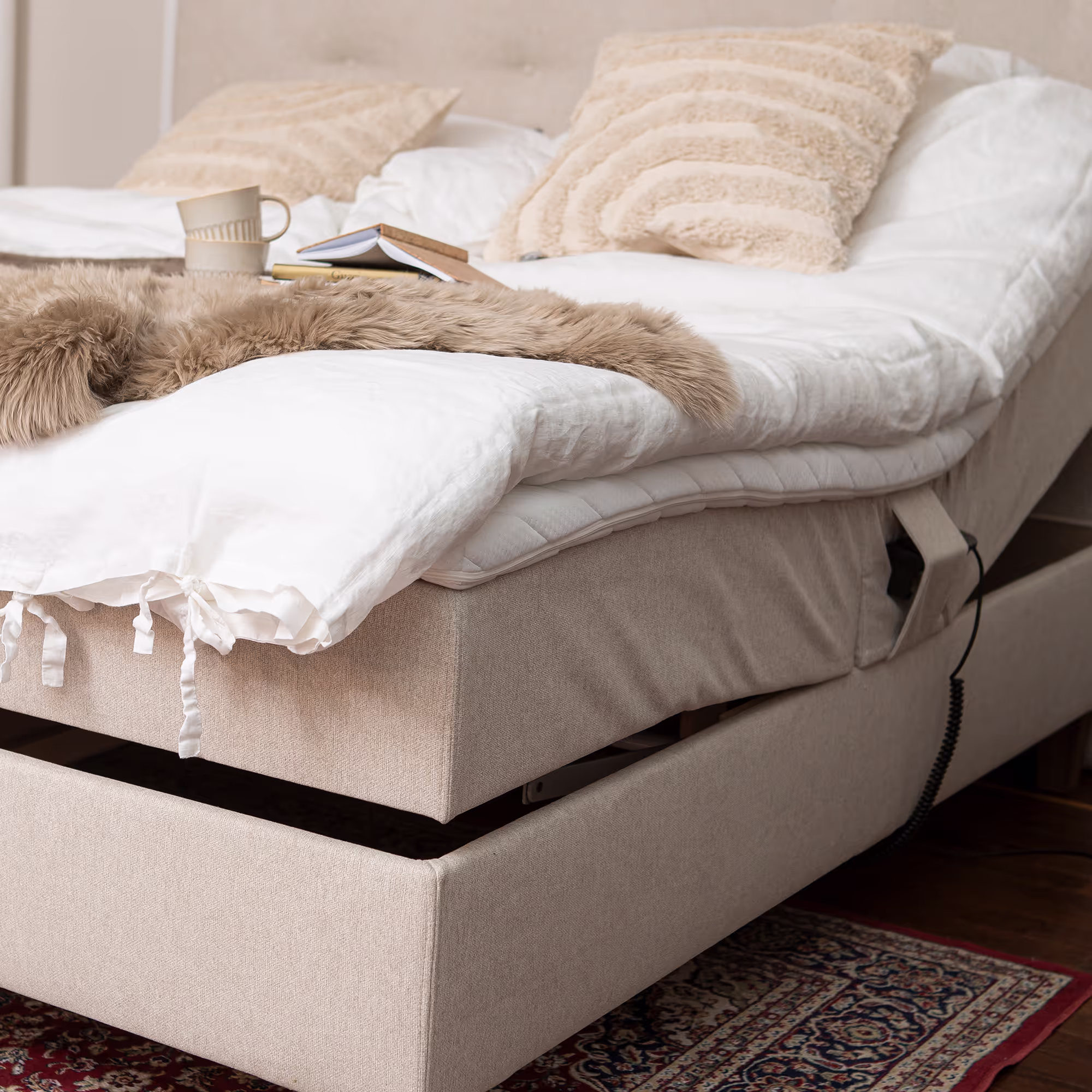 Side view of the Moon Gold motorized bed highlighting adjustable frame and light beige upholstery in elegant contemporary bedroom setup