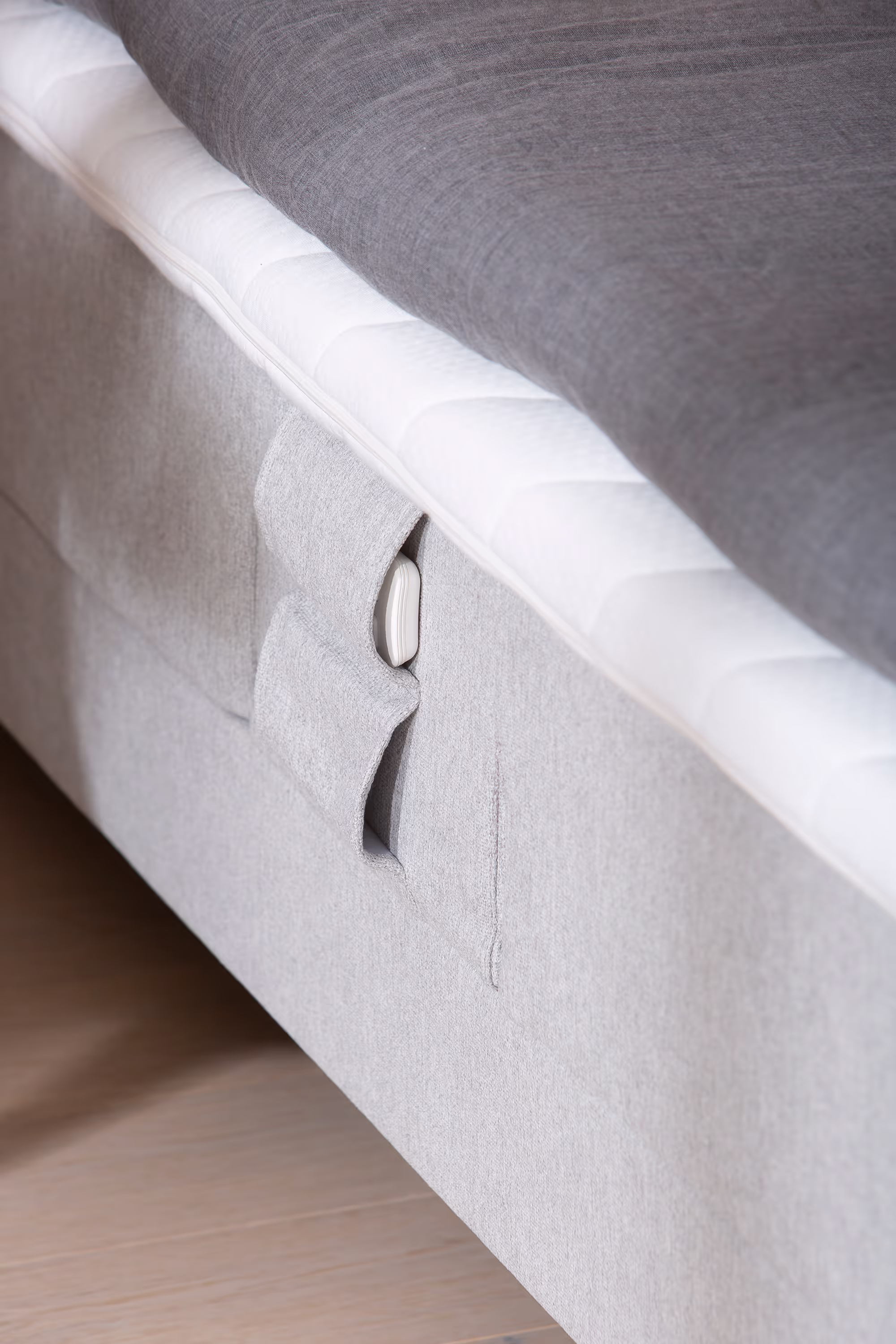 Side view of Moon Silver motorized bed with visible tall cone-shaped 15 cm smoked ash legs