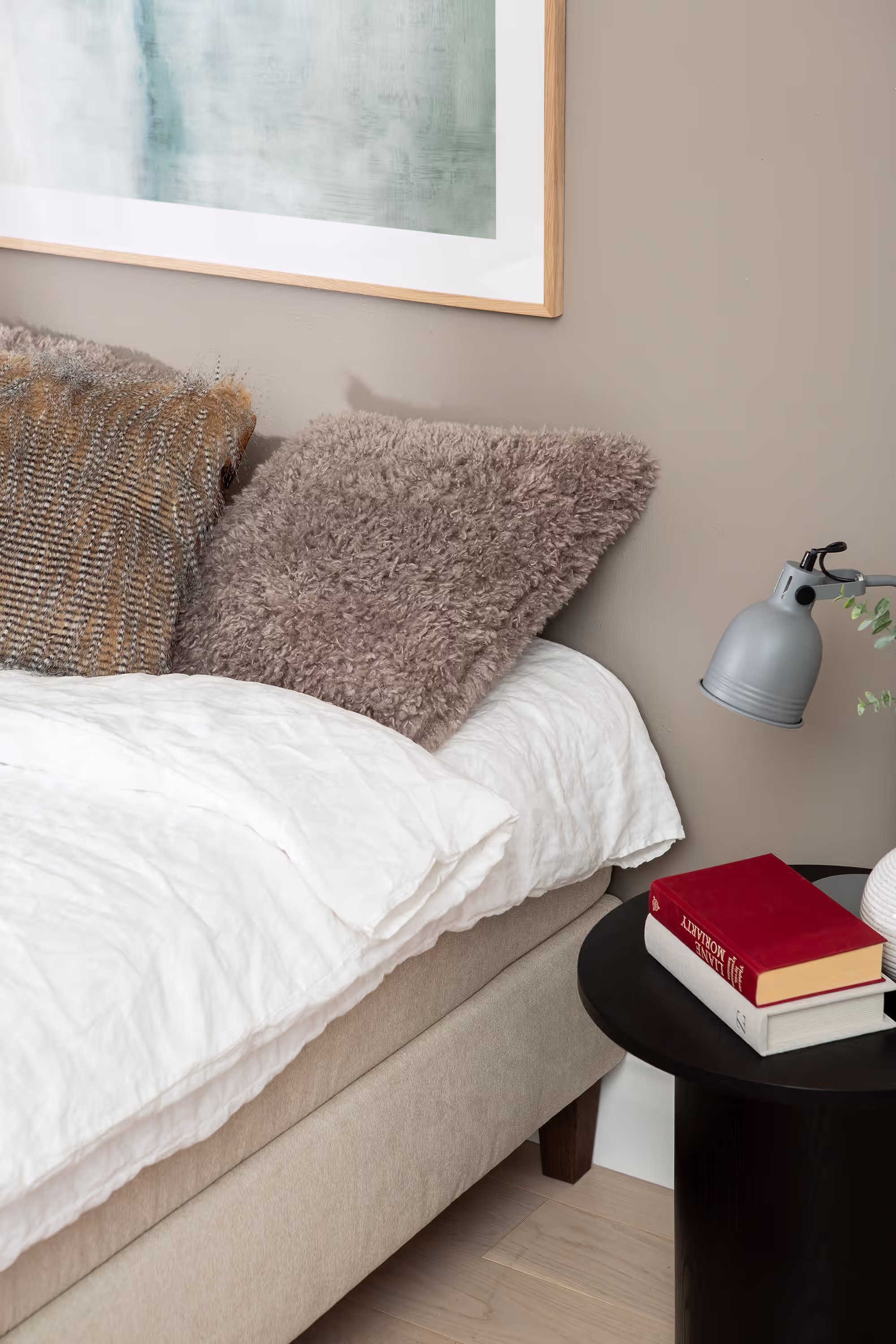 Close-up of the Moon Gold continental bed’s beige Primo 05 fabric upholstery and cushioned surface for enhanced comfort.