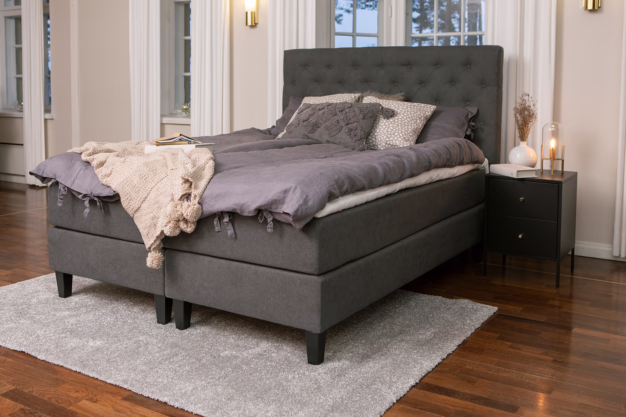 Close-up view of the Moon Gold continental bed highlighting the anthracite Primo 96 fabric upholstery and comfortable visco mattress layer.