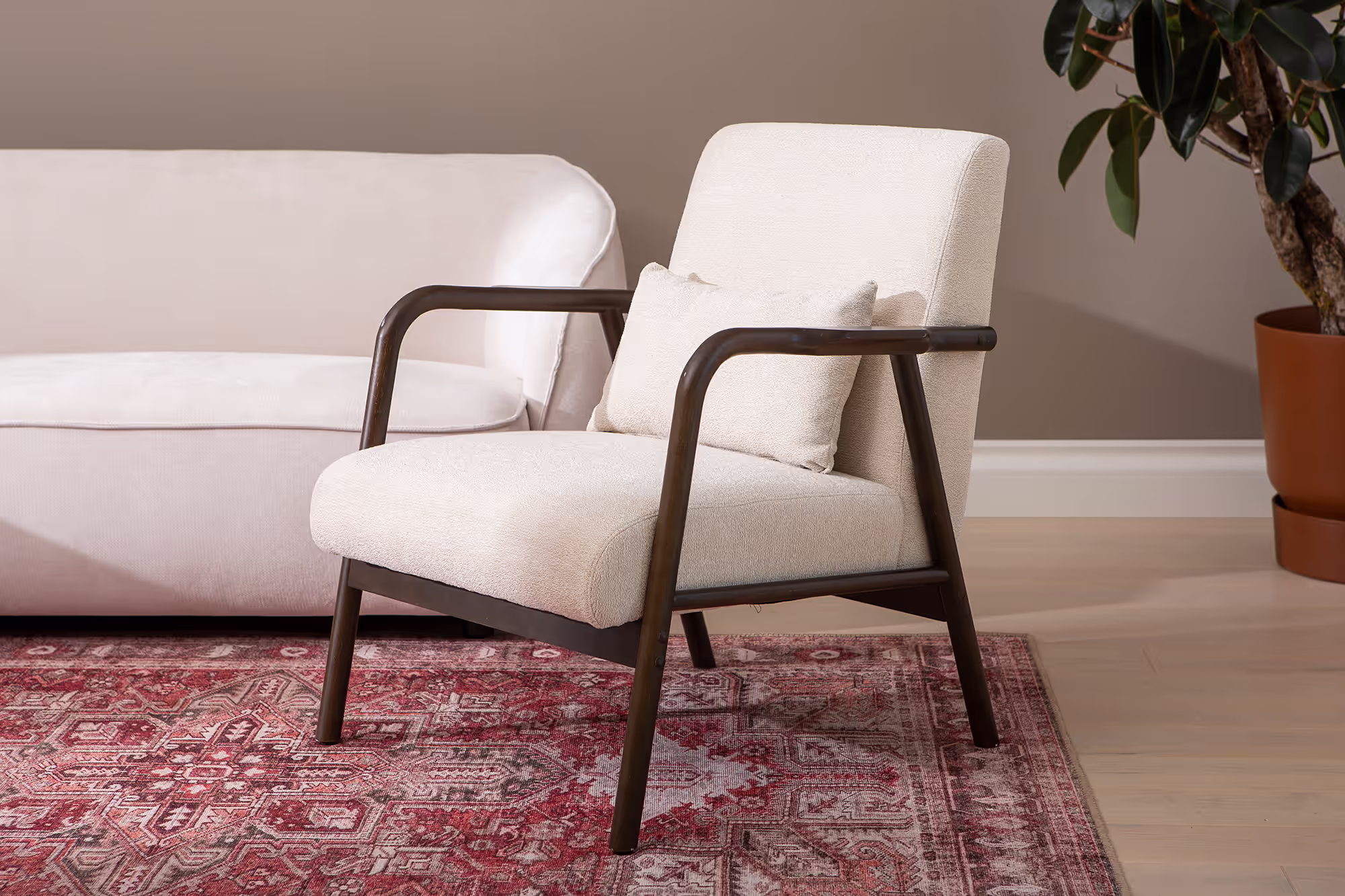 Back of Dove armchair highlighting smooth walnut wood finish