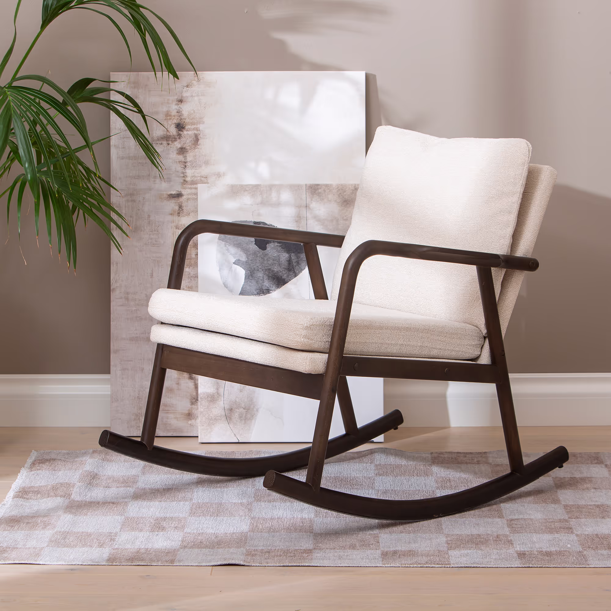 Elegant silhouette of Swan rocking chair with gentle rocking base made of walnut rubberwood.