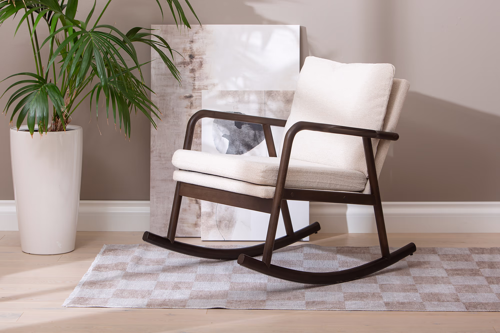 Swan rocking chair shown from above, highlighting spacious seat and soft beige upholstery.