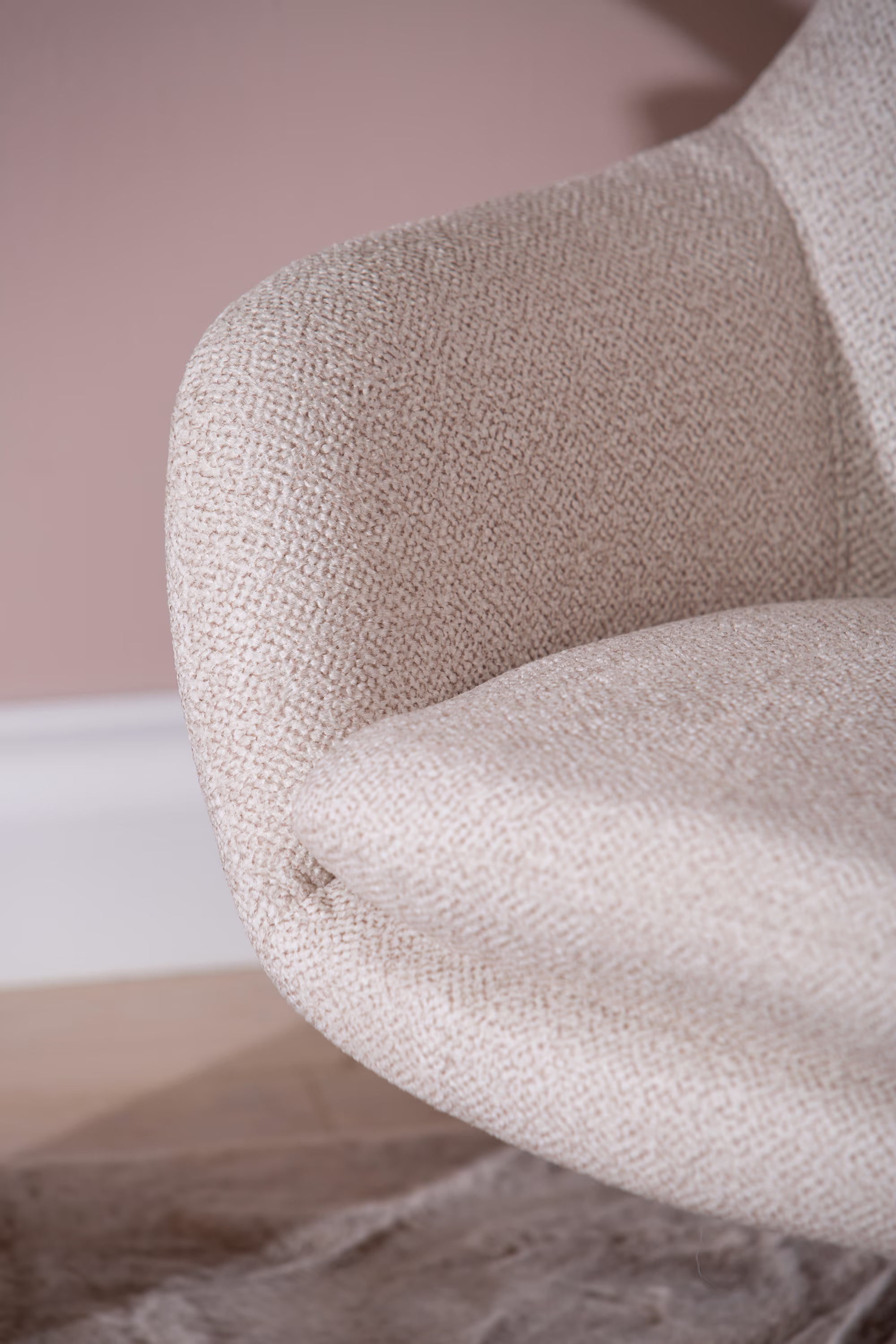 Close-up of Blow TV chair armrest and fabric texture in soft beige tone
