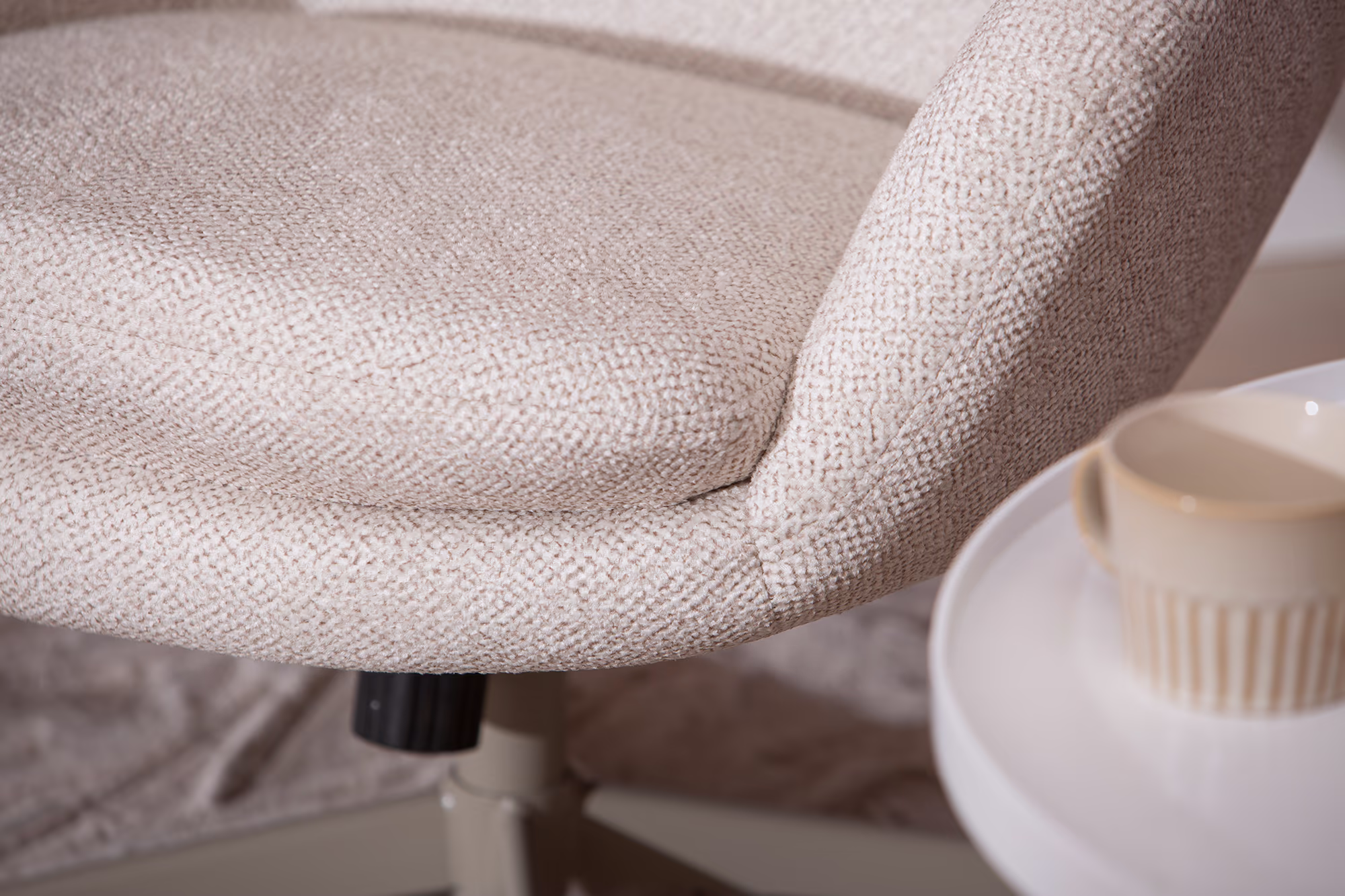 Detailed shot of latte-colored leg and base supporting the Blow TV chair