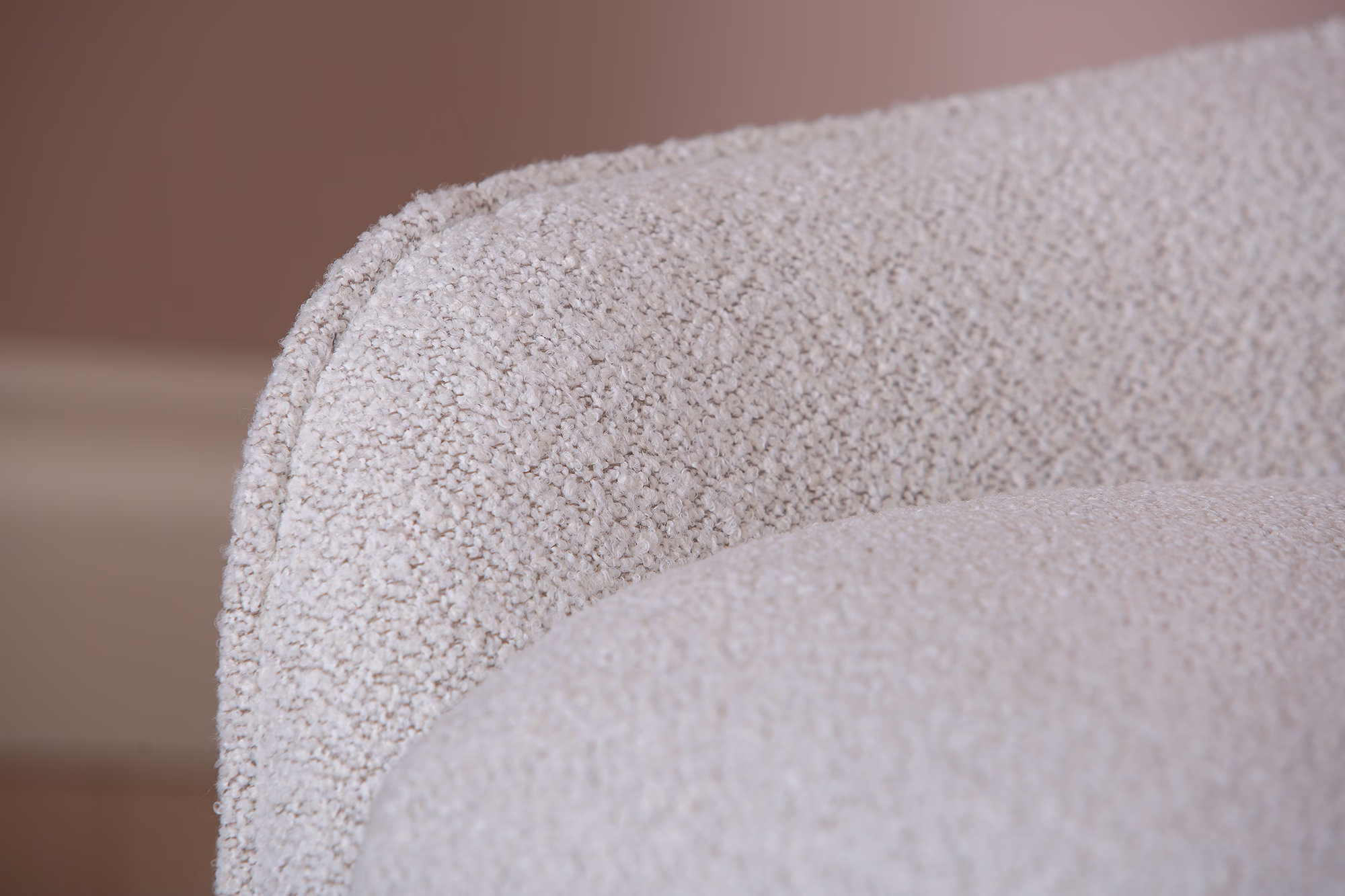 Close-up of the Breeze TV chair’s padded cushions and ergonomic design in light beige fabric.
