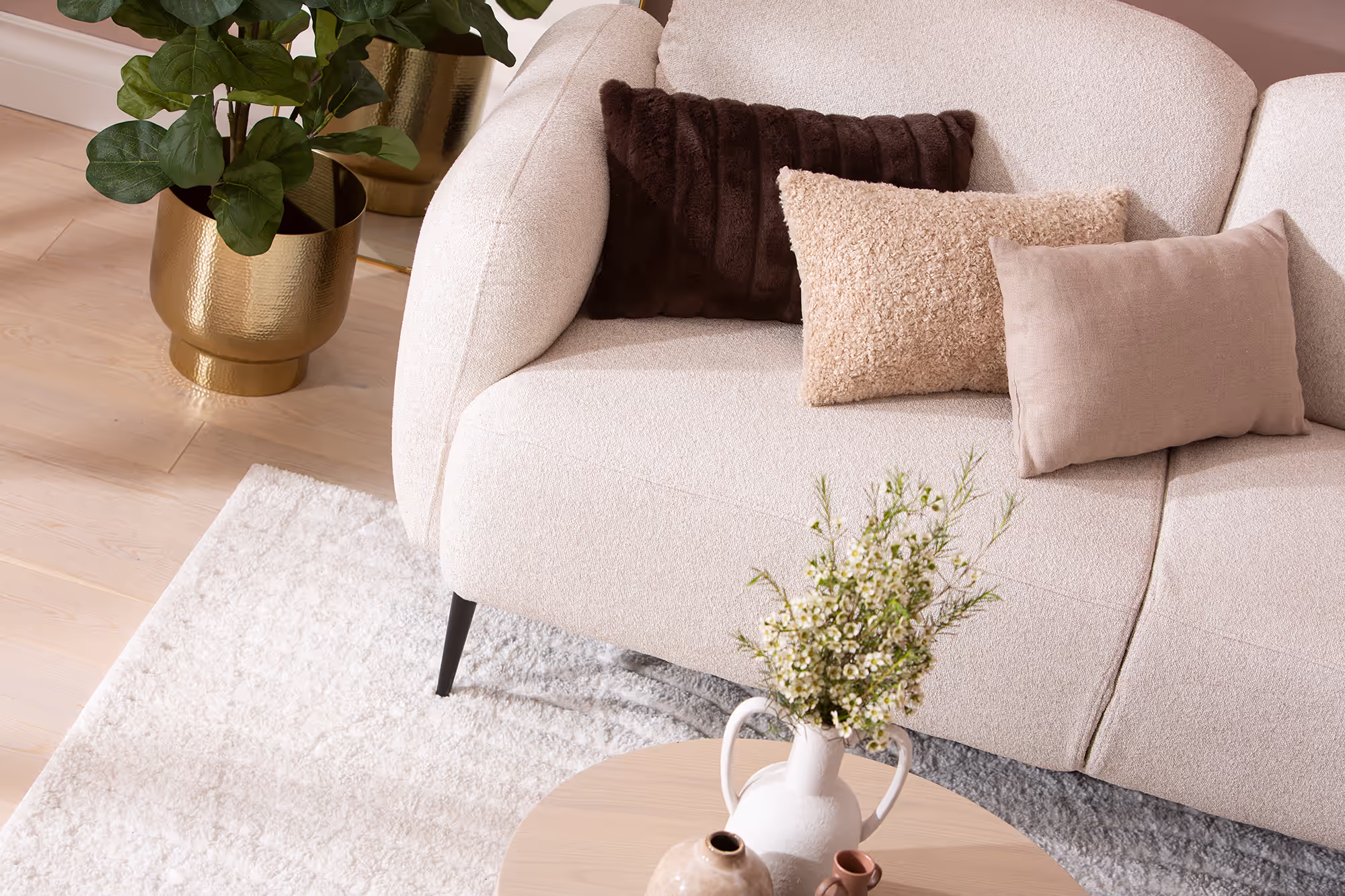 Side profile of the Cloud sofa highlighting minimalist frame and elevated design on black legs