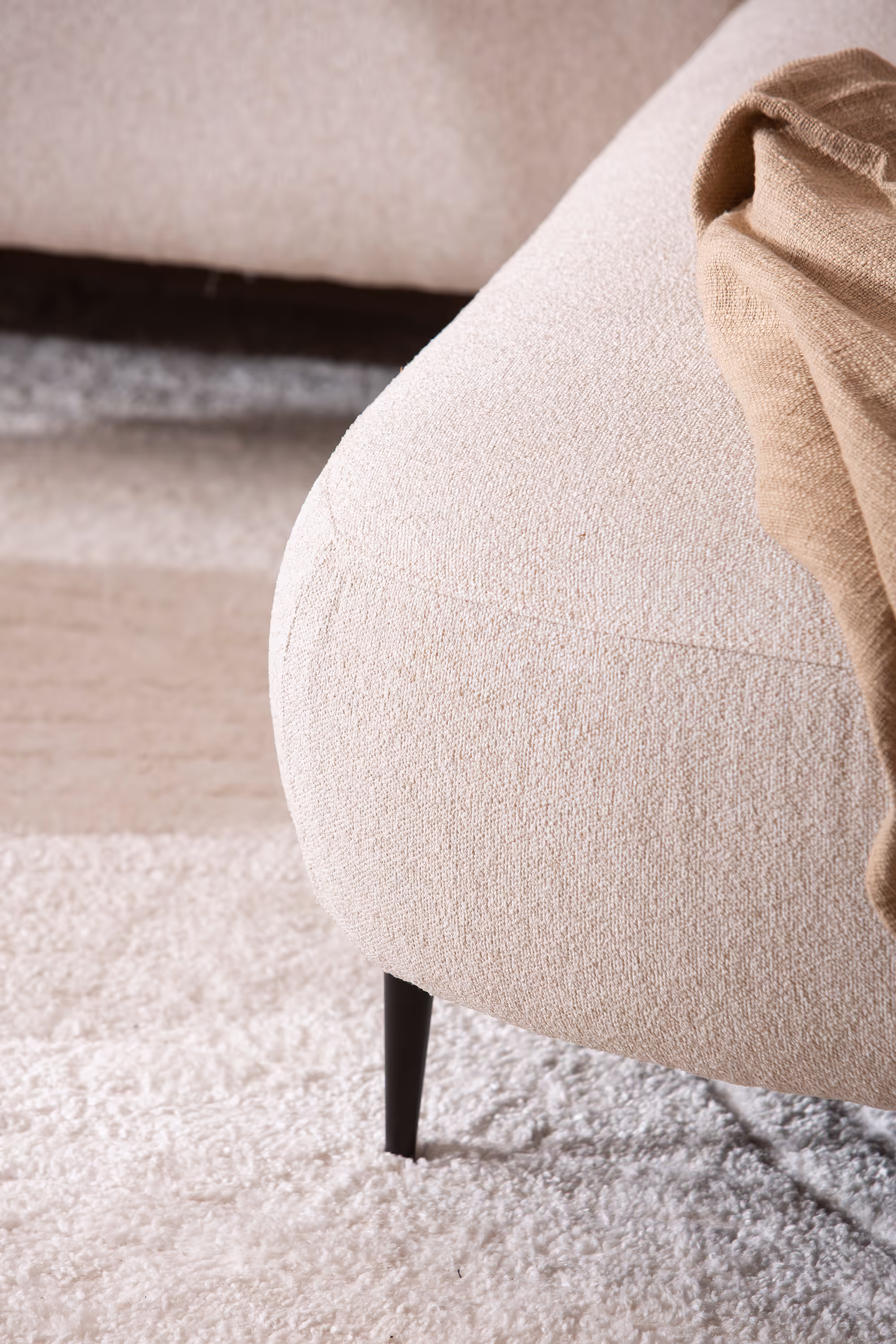 Detailed shot of sofa stitching and fabric weave in light grey hue