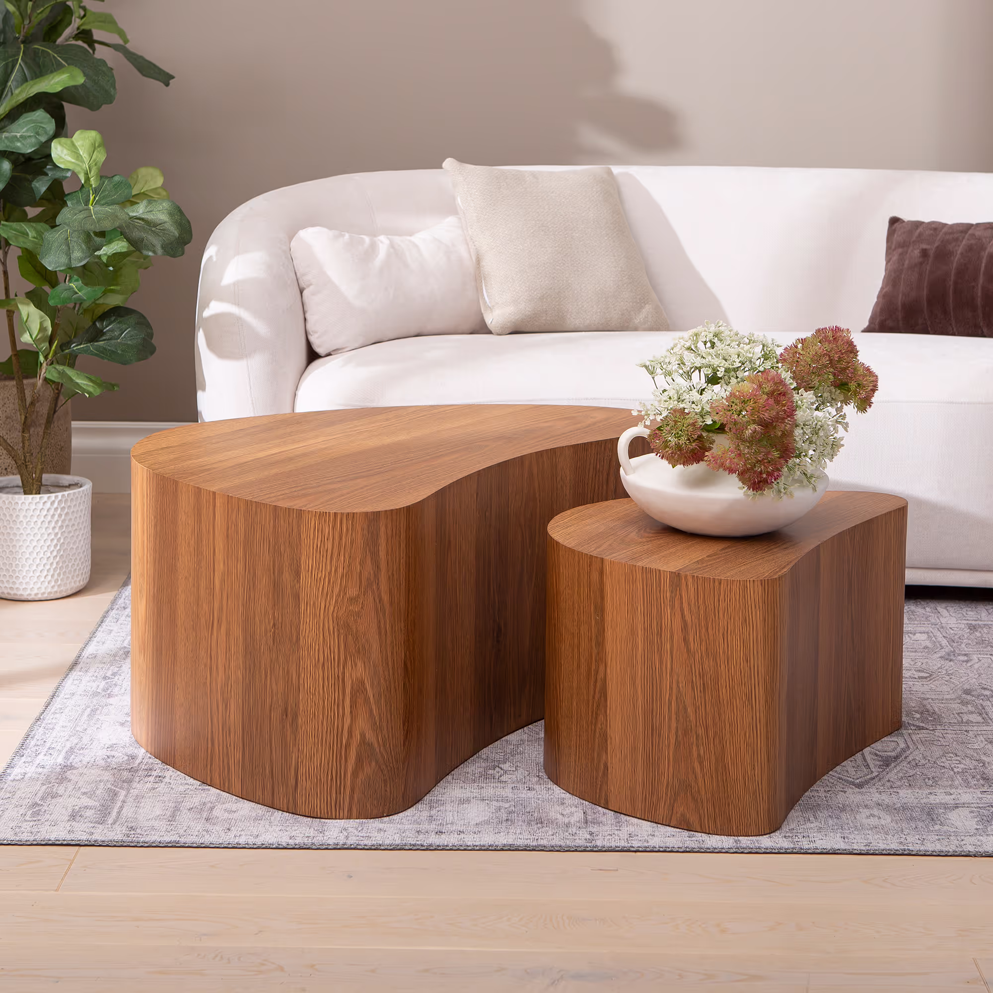 Full view of Island series tables set in a minimalist interior with soft natural lighting