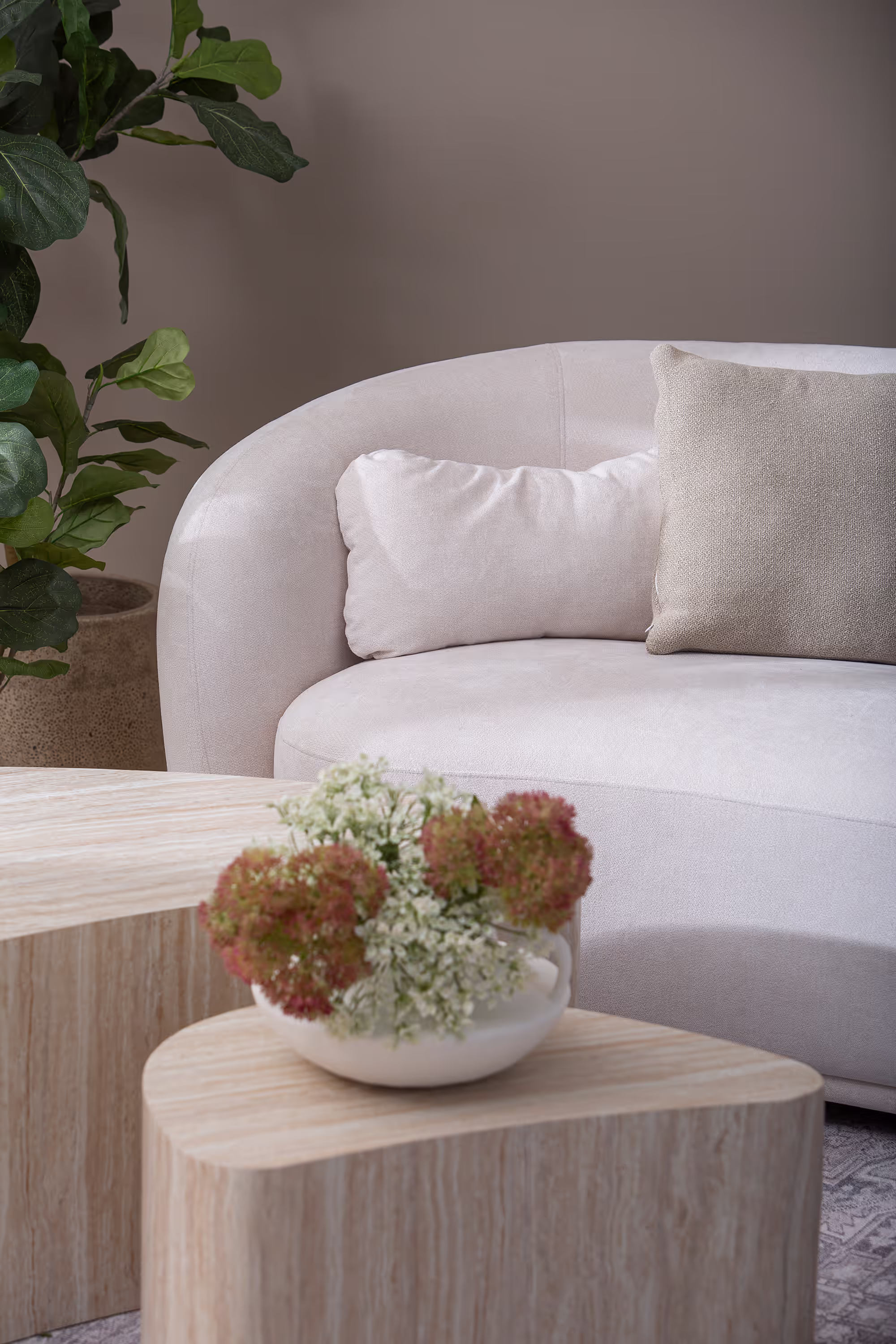 Island series coffee table set showing two beige tables of different sizes arranged in a Scandinavian style living room.