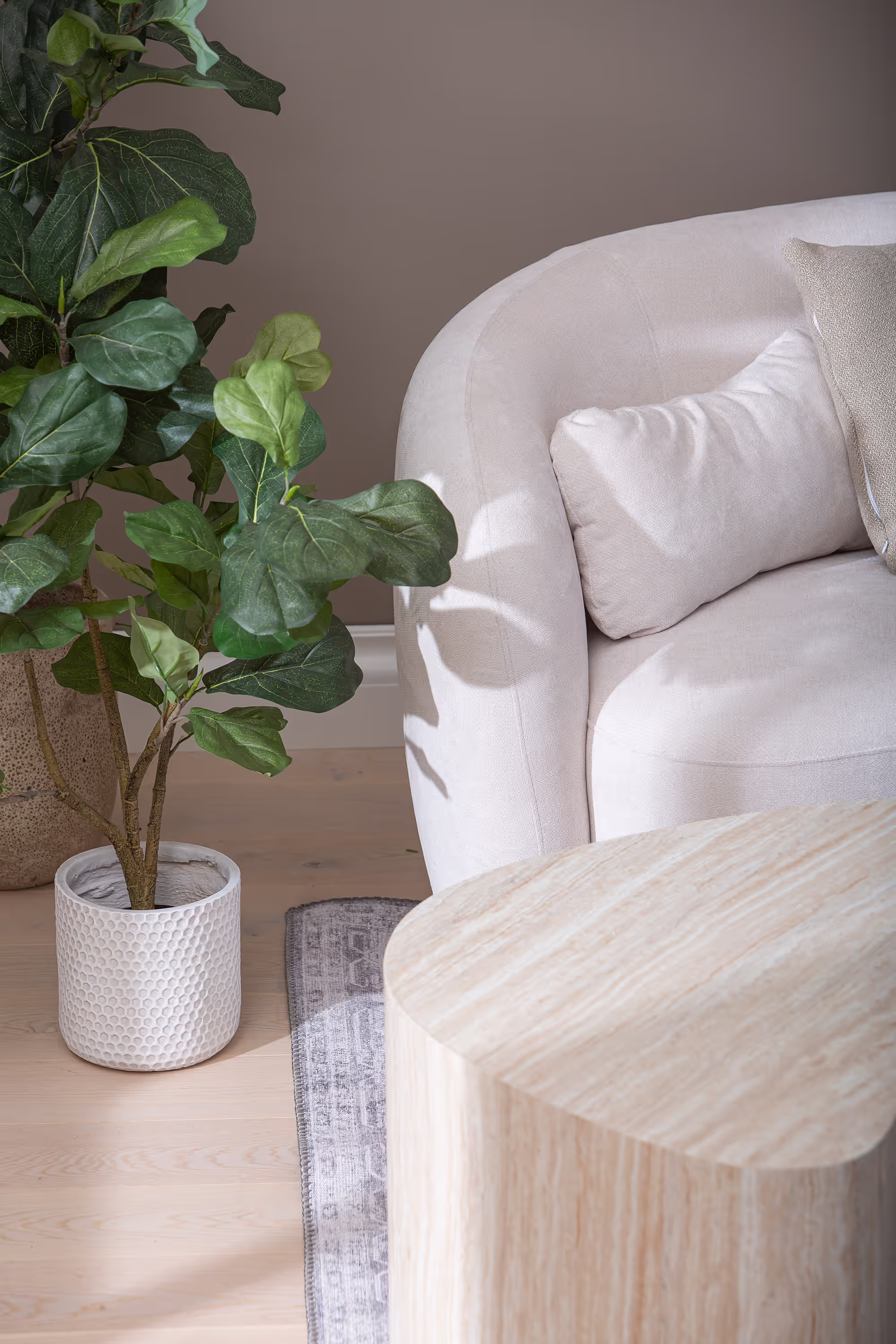 Two Island series tables shown separately with one used as a side table holding a lamp.