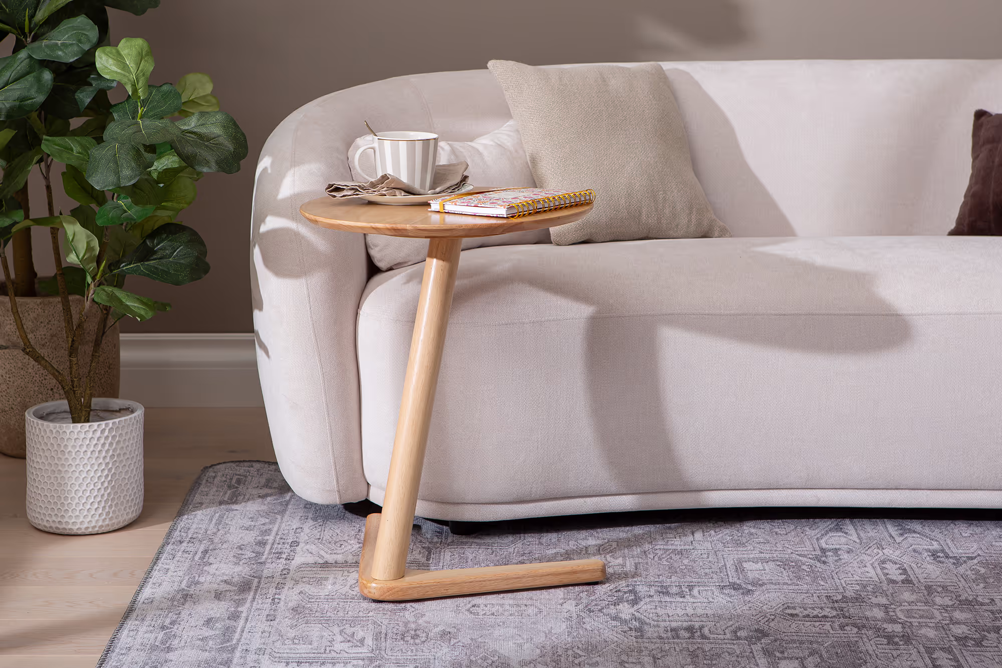 Close-up of the Swallow side table leg’s gently rounded edge and natural wood texture