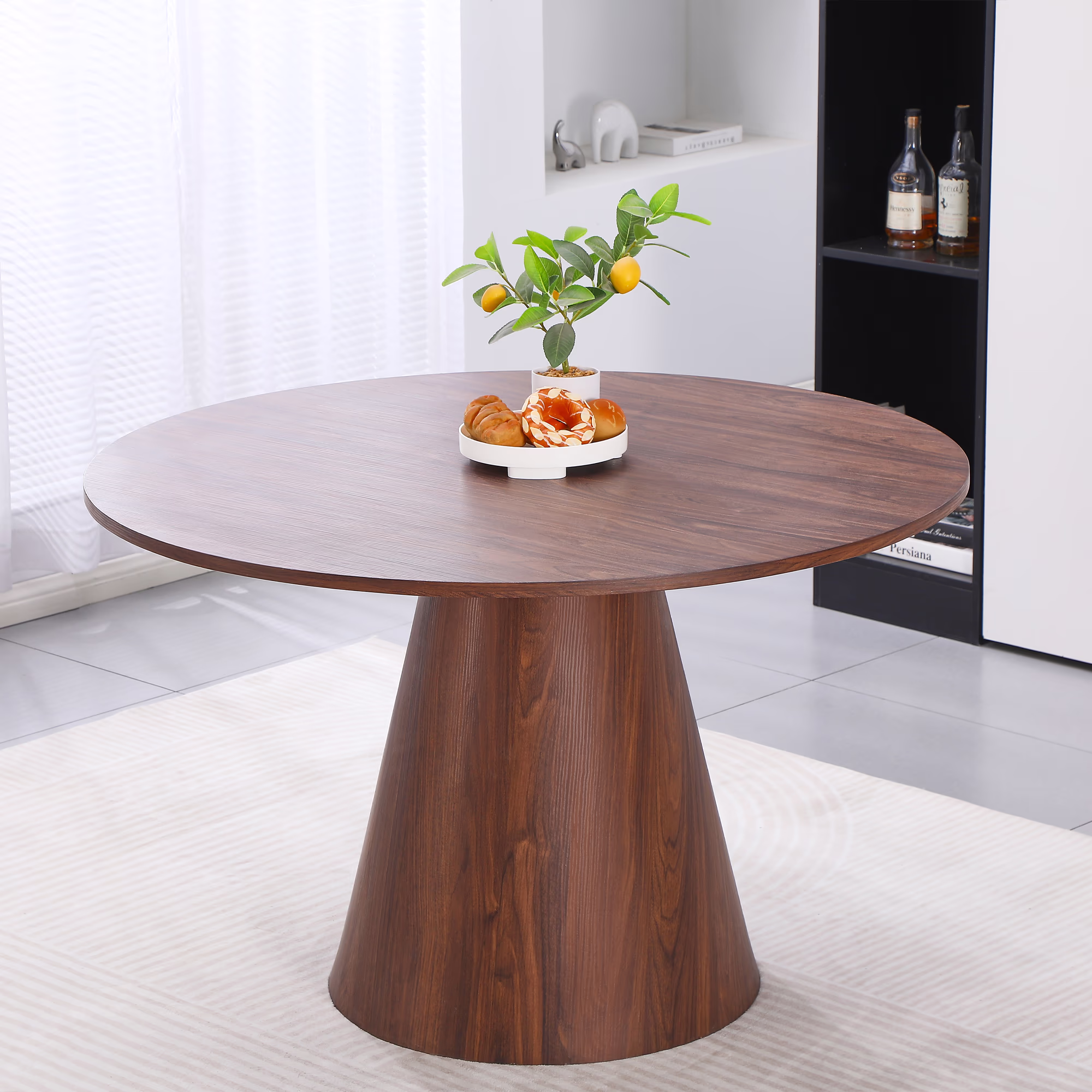 Close-up of Islet dining table’s round edge and walnut wood tone highlighting clean design details